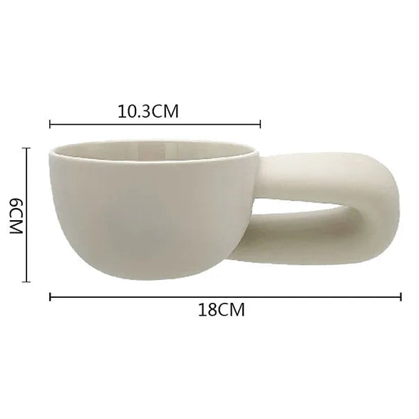Beige ceramic cup with handle and measurements on a white background