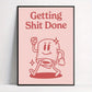 Framed poster with a cartoon character and text 'Getting Shit Done' on a pink background