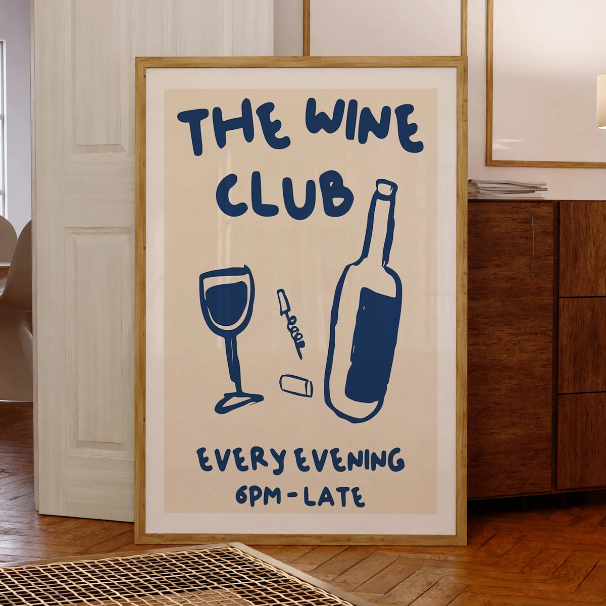 Framed poster with 'The Wine Club' text and wine graphics in a room setting.